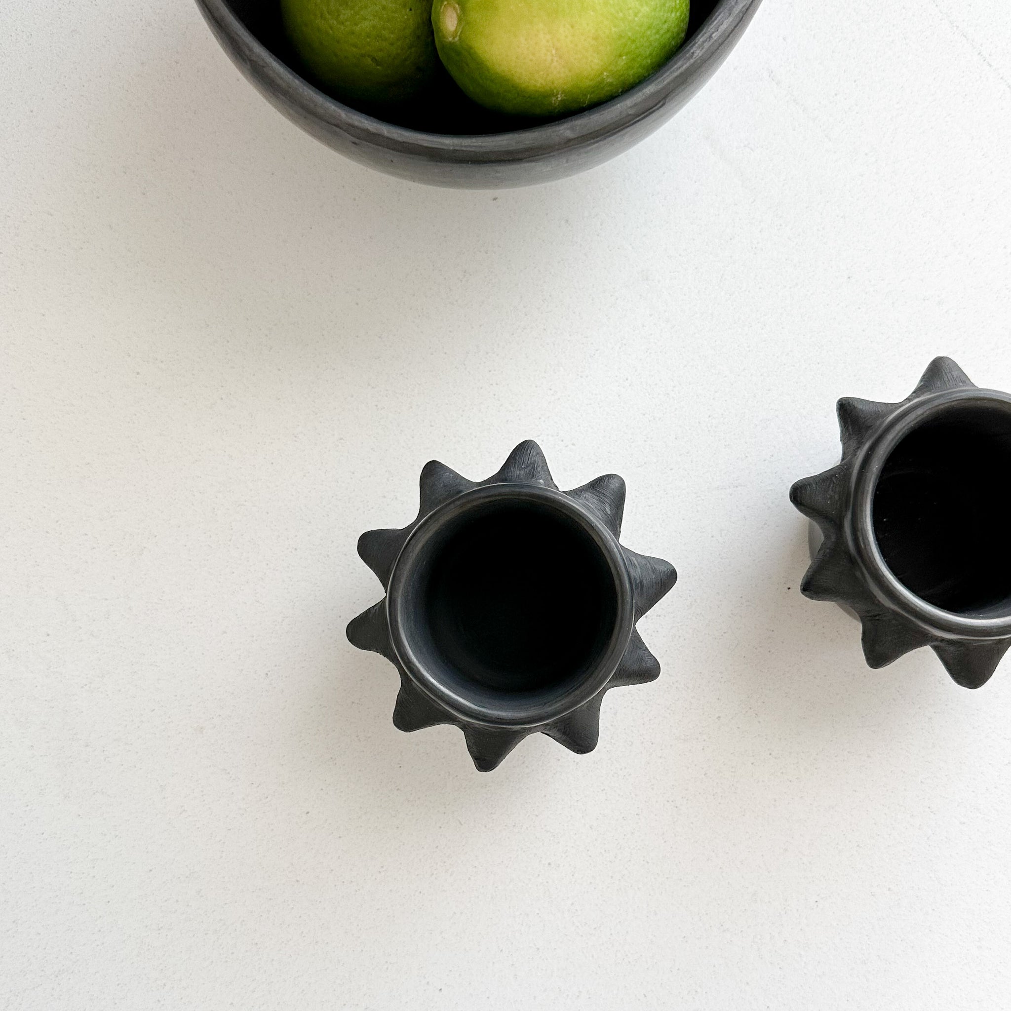 A set of 2 black clay spiky cups made in Oaxaca.