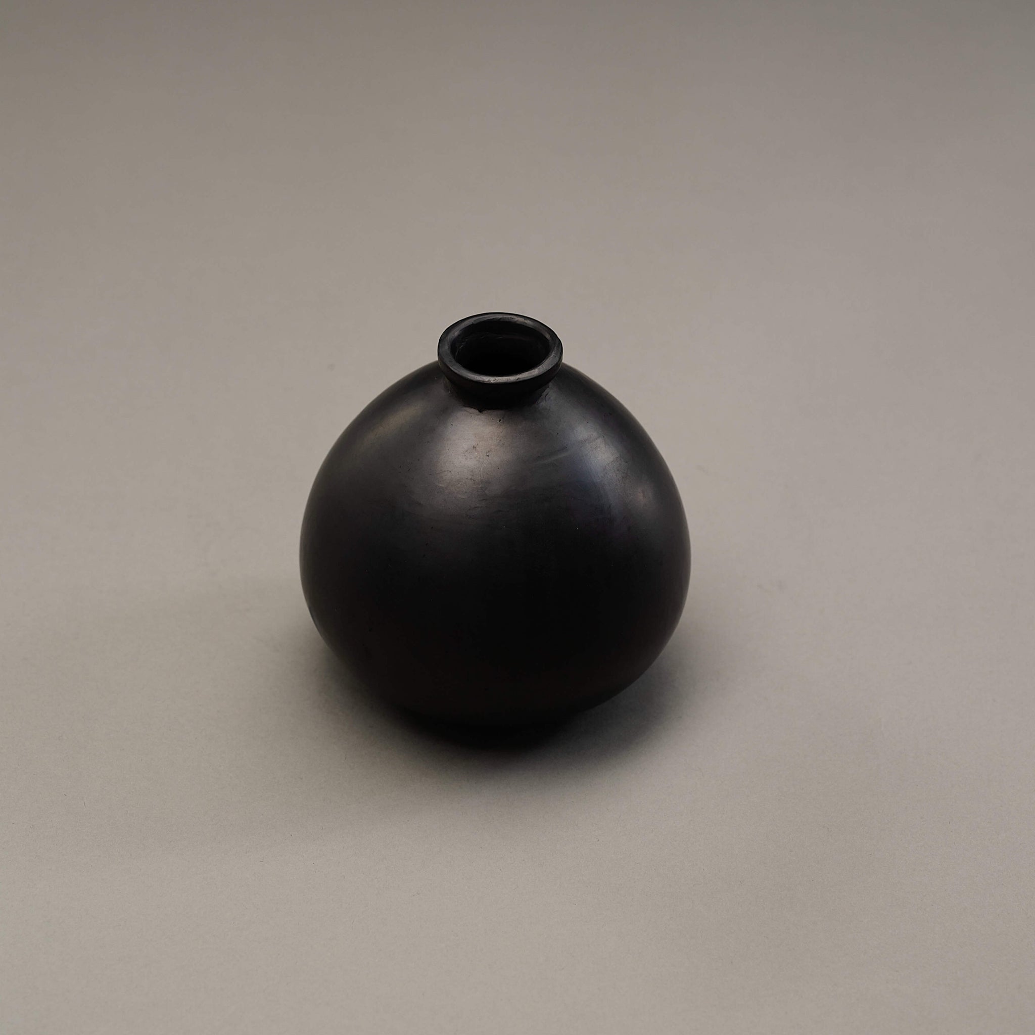A black clay vase.