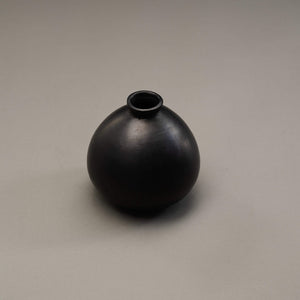 A black clay vase.