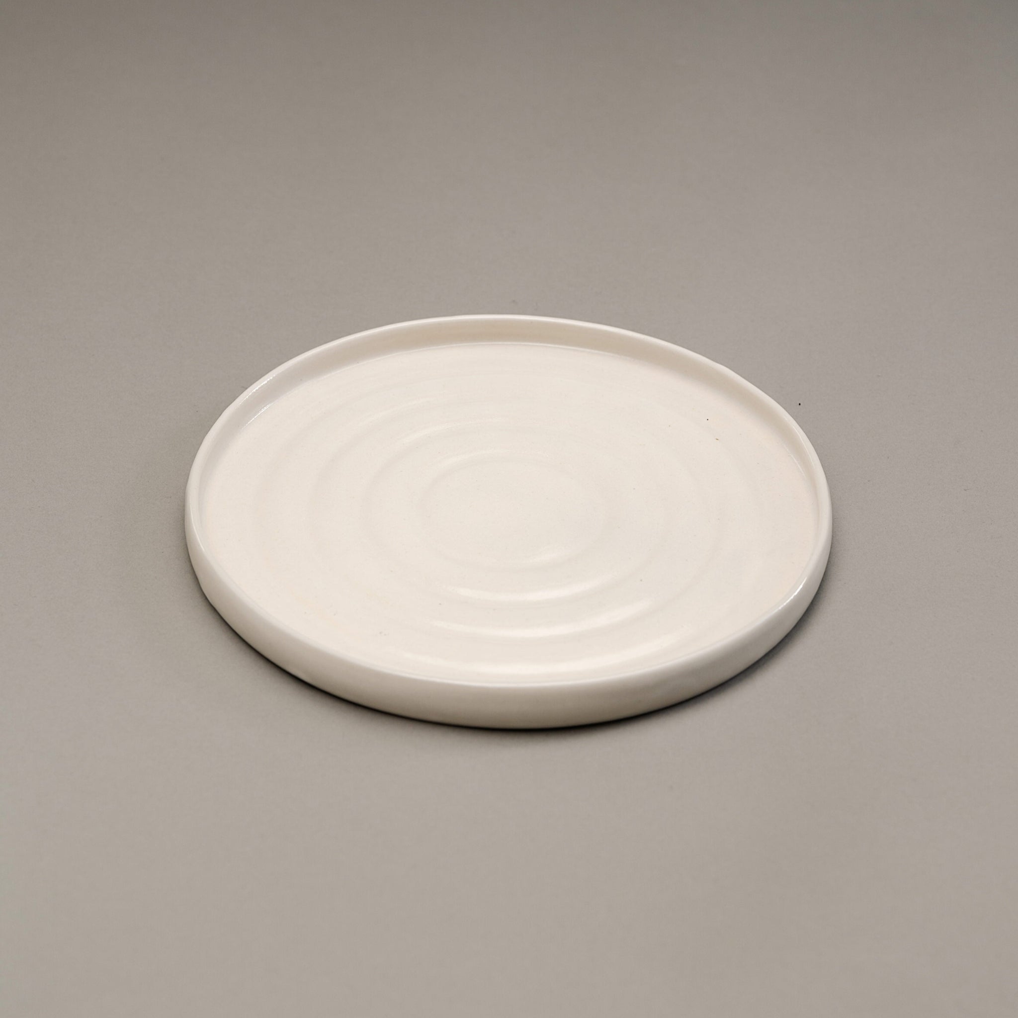 A stoneware dinner plate in a white finish.