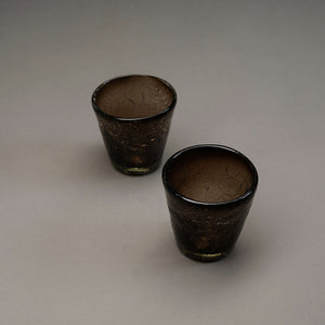 A pair of smoky v-shaped glasses featuring a crackle finish.