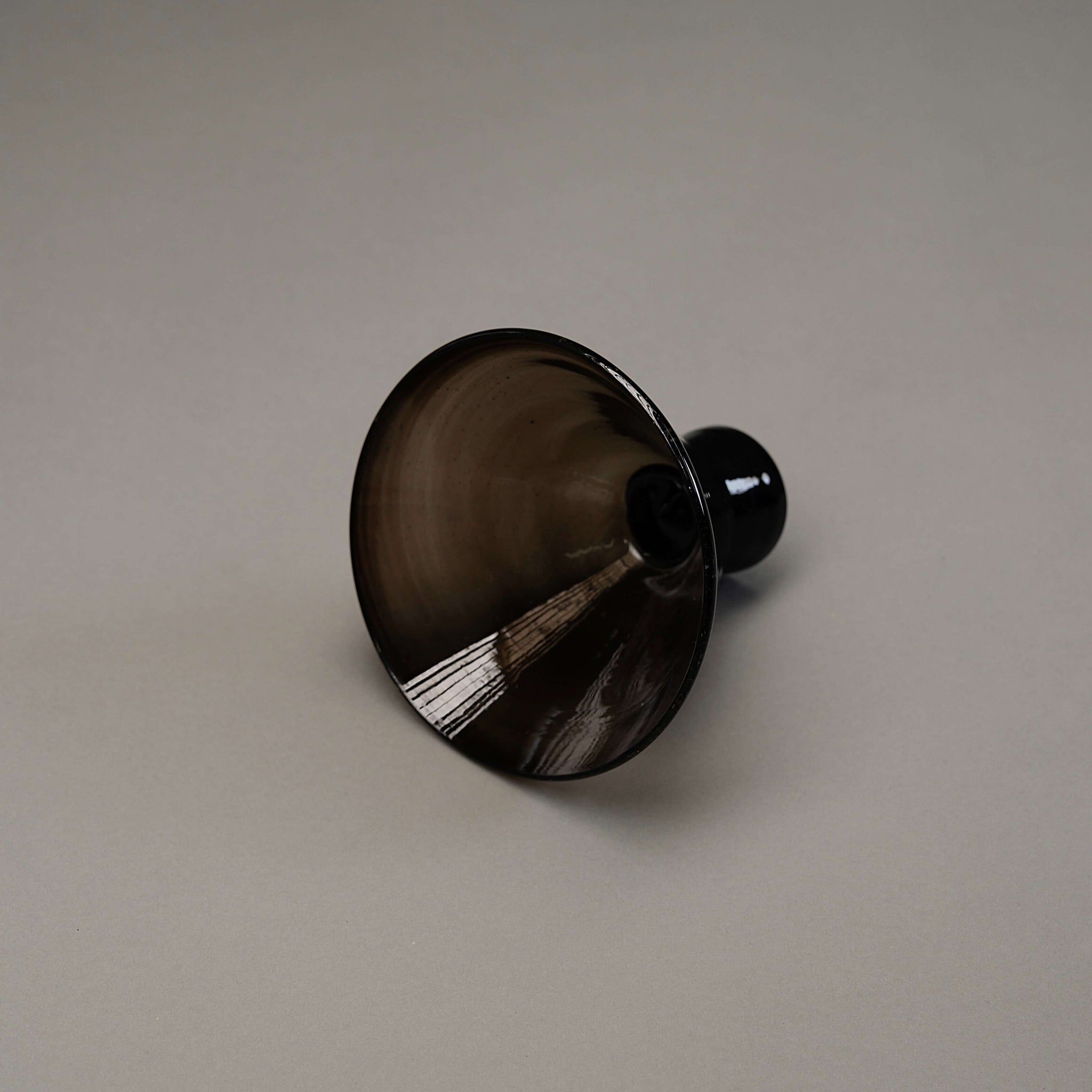 Small footed glass bowl in black.