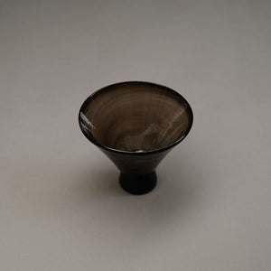 Small footed glass bowl in a deep smoke color.