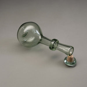 Small glass decanter with a cork stopper.