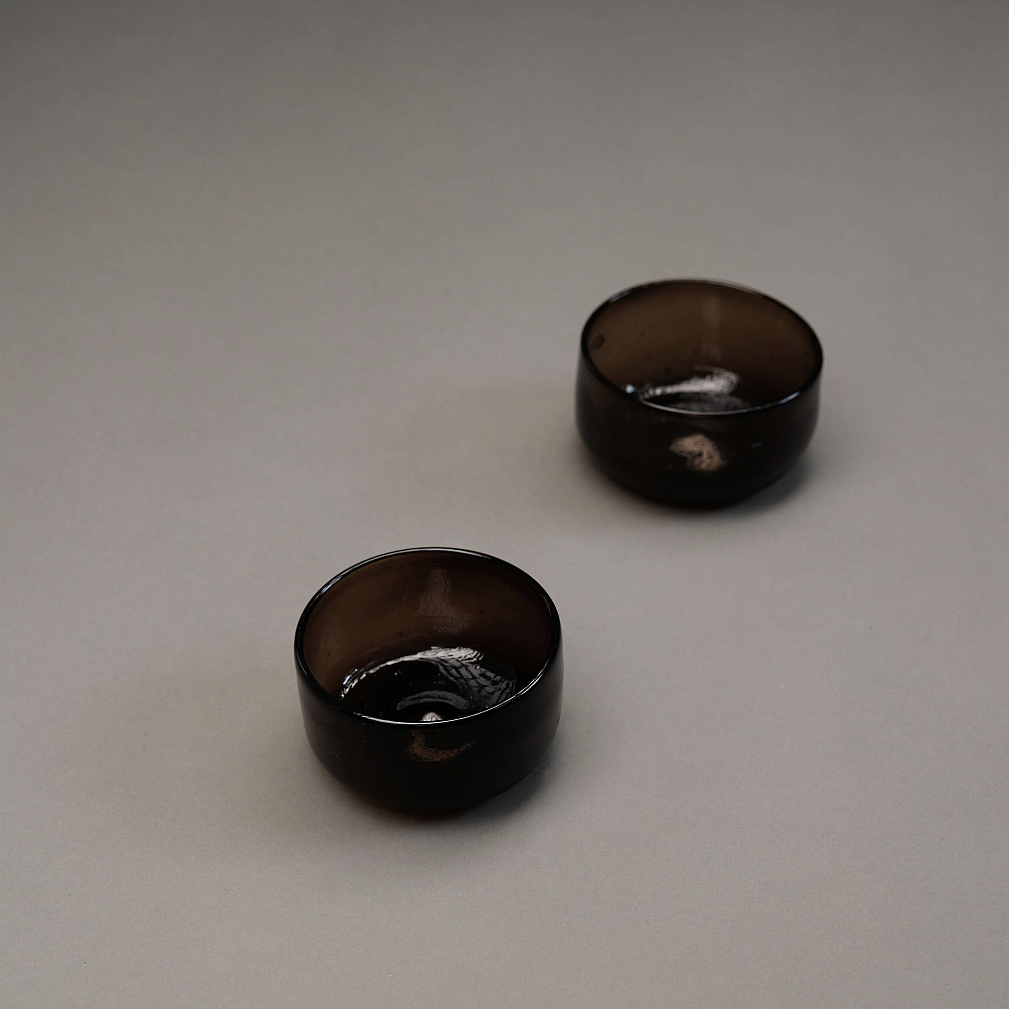 Small set of 2 smoky glass pinch bowls.