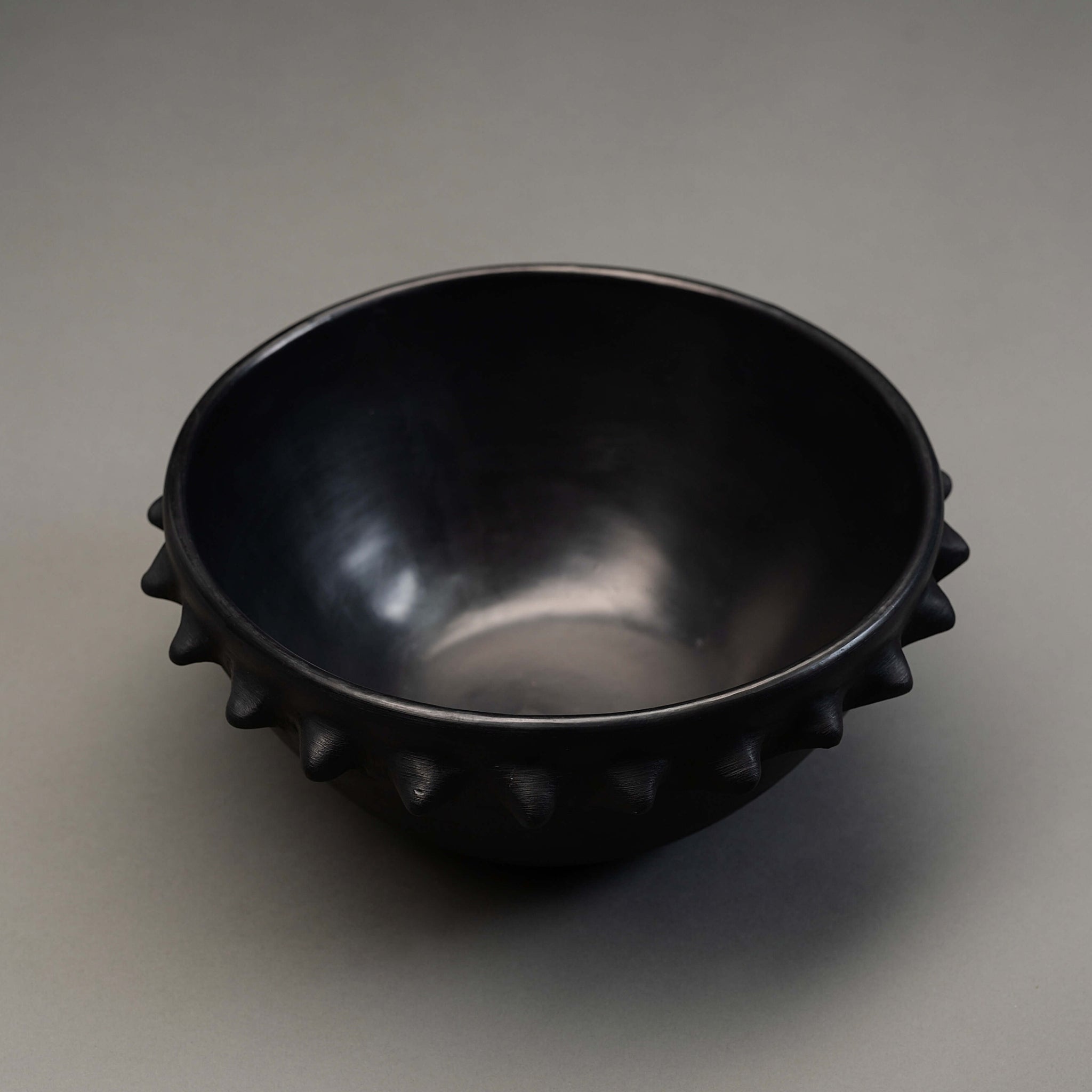 A black clay spiky serving bowl from Oaxaca.