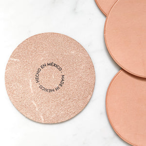 The reverse stamped details on a nude leather coaster made in Baja, Mexico.