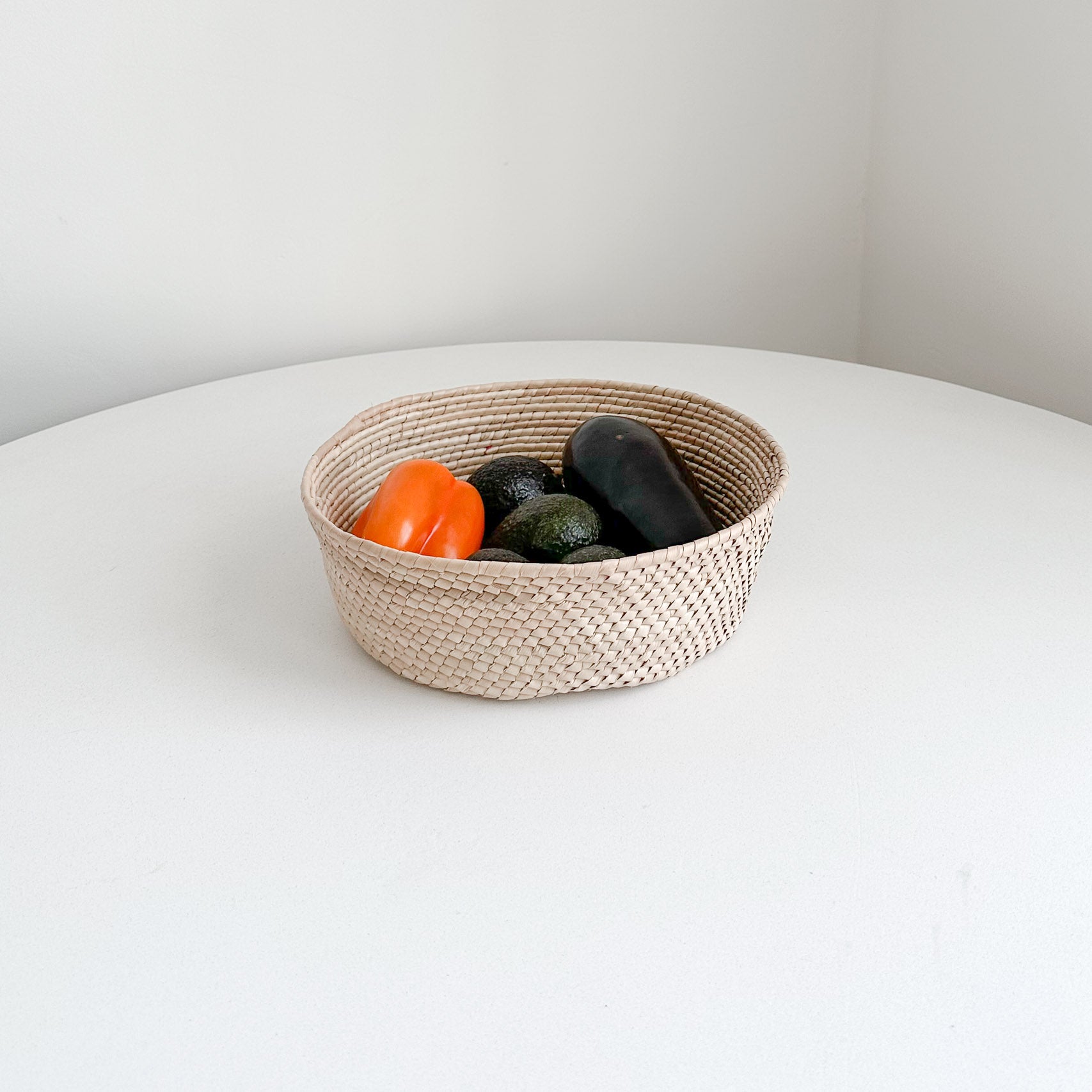 Baja palm storage basket with fruit.