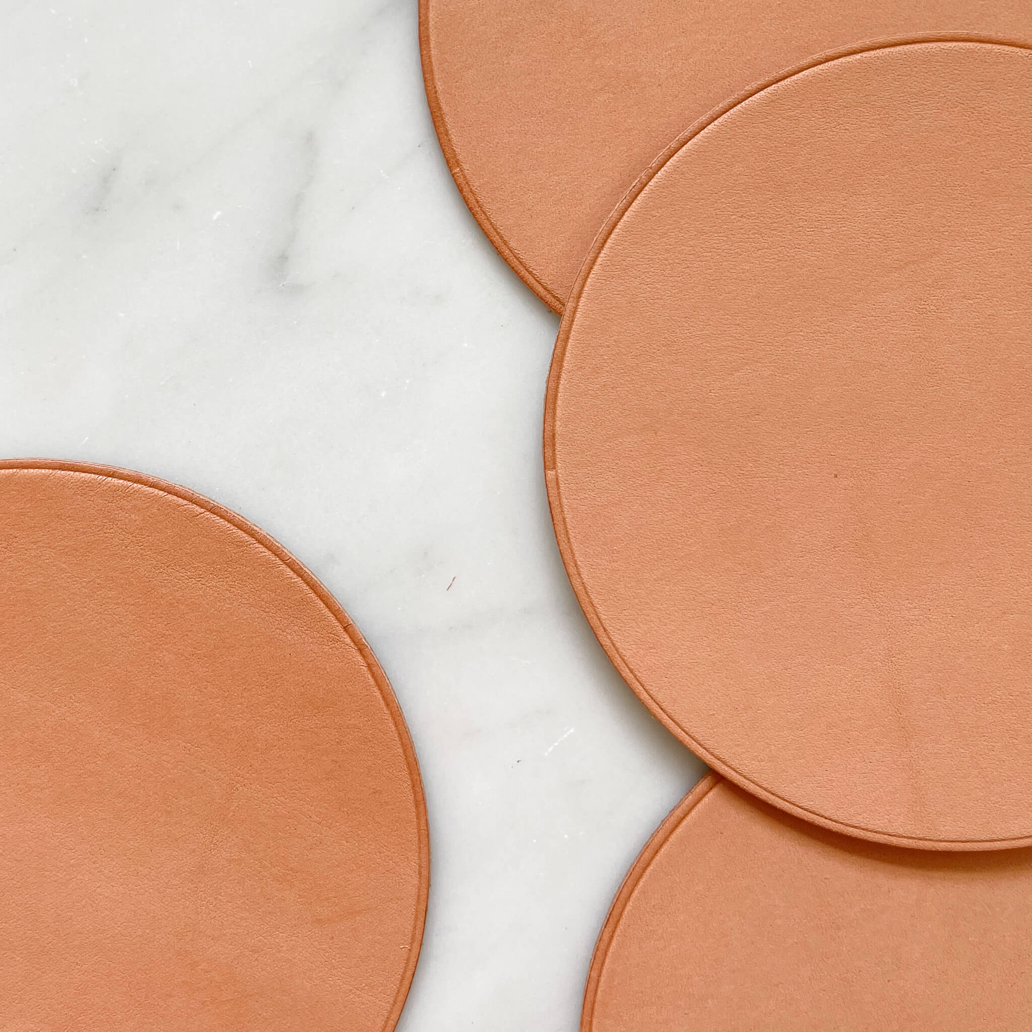 The details on a leather coaster in natural nude made in Baja, Mexico.
