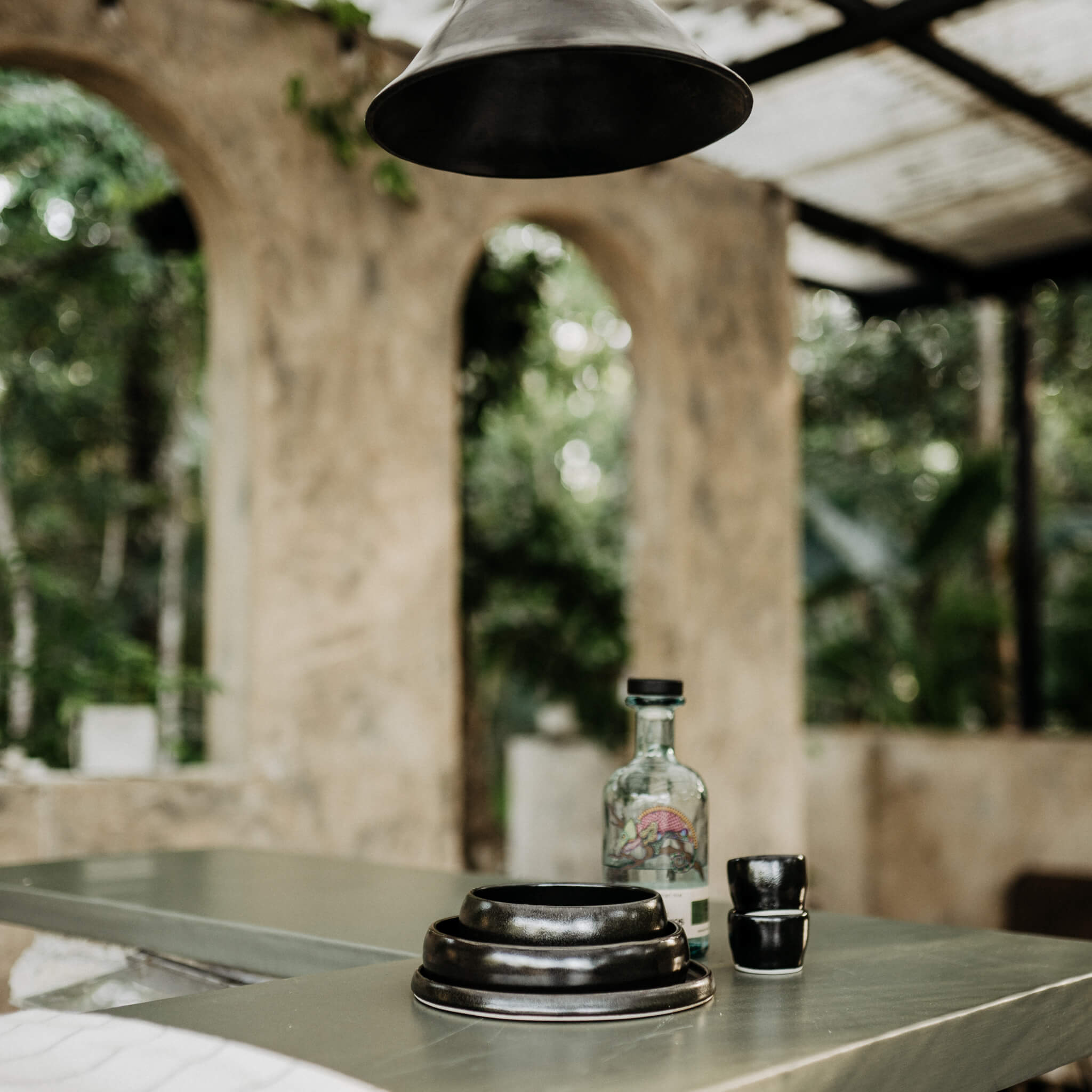 Black ceramic dishes on an outdoor counter in Mexico.