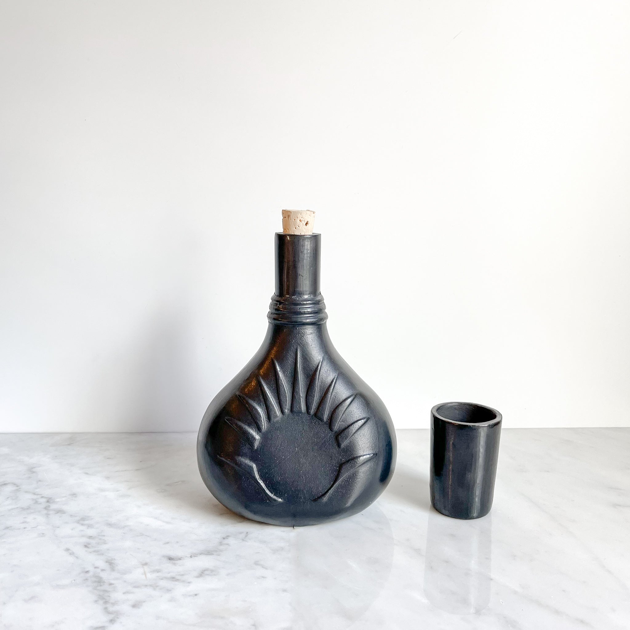 Black clay mezcal vessel with an agave inspired design handmade in Oaxaca, Mexico.