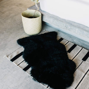 A black sheepskin 2'x4' rug.