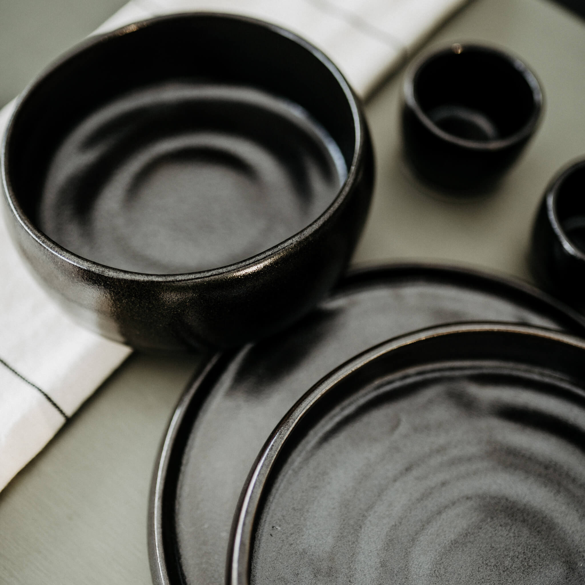 Black stoneware dining dishes made in Mexico.