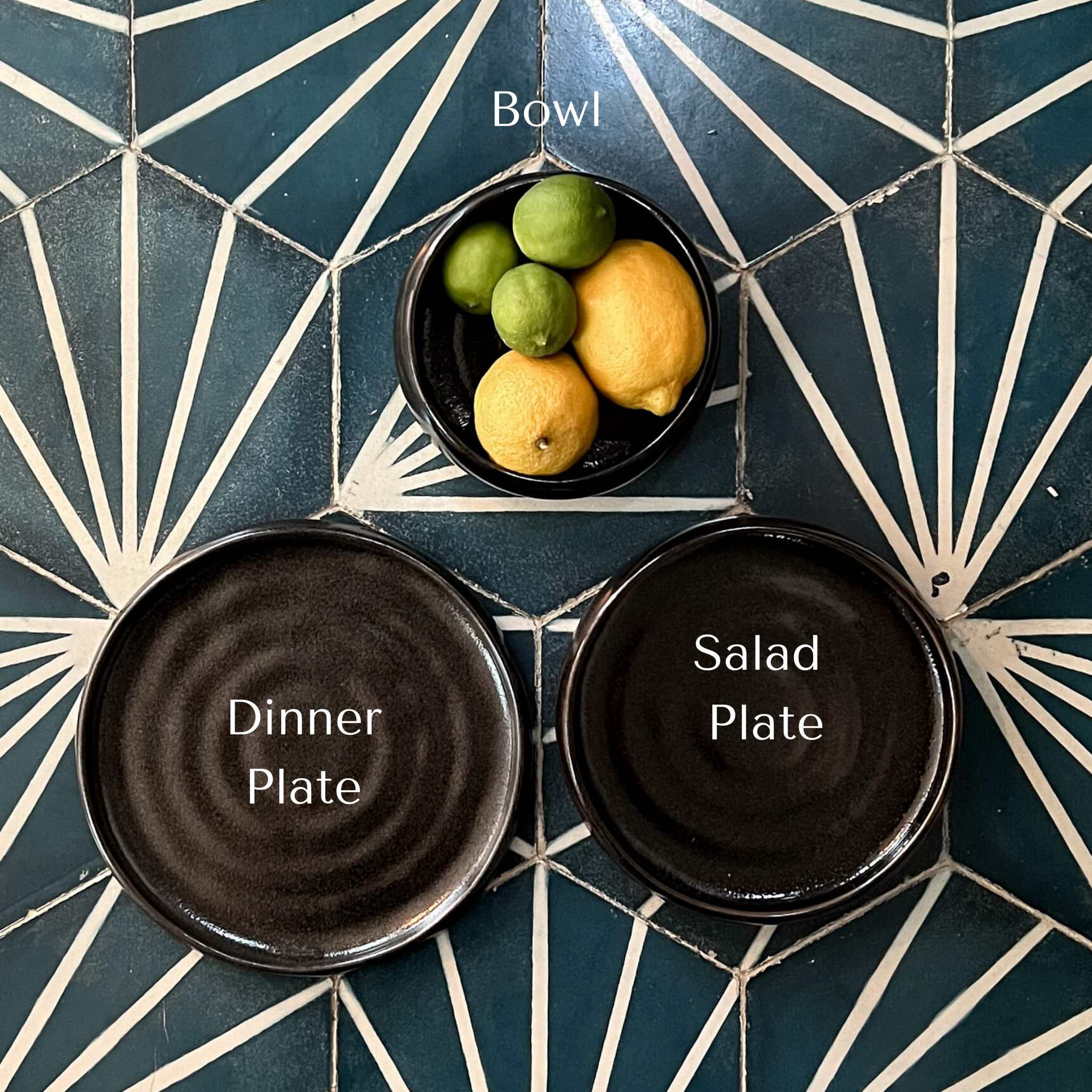 A set of black stoneware dishes including a dinner plate, salad plate and bowl made in Mexico.