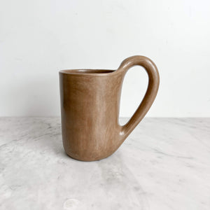 A Calapa beige clay mug.