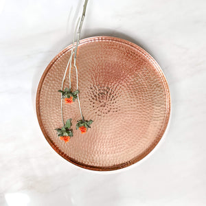 A medium, 16 inch hammered copper serving tray.