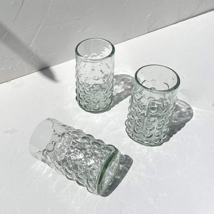 Handblown glass tumblers made of recycled glass.