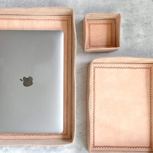 A set of 3 Javier leather trays in multiple sizes, with one holding an Apple laptop computer.
