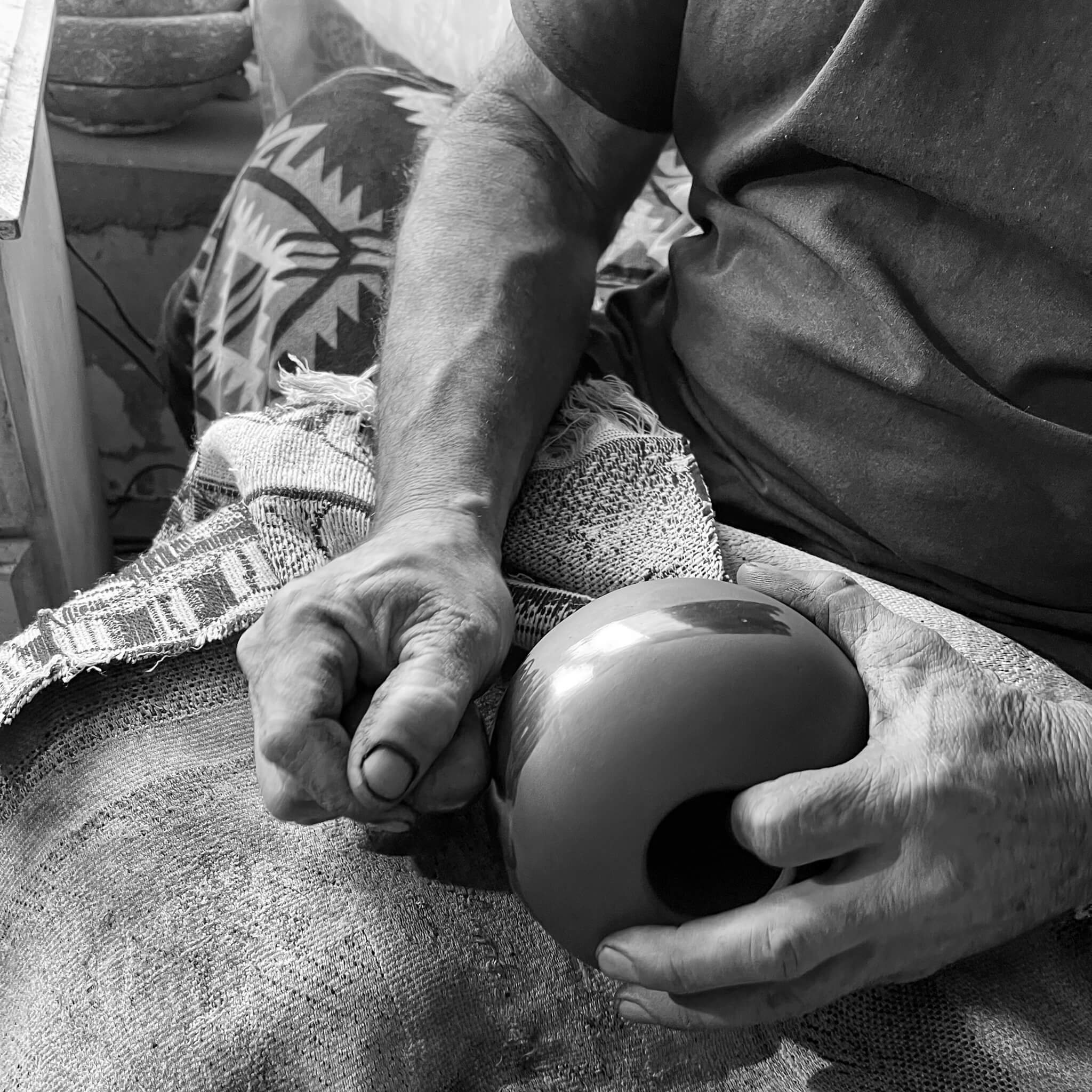 A Mexican artisan hand-burnishing pottery in Mata Ortiz, Mexico.