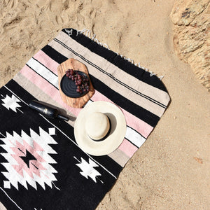 A Mexican beach blanket featuring a La Rosa design.