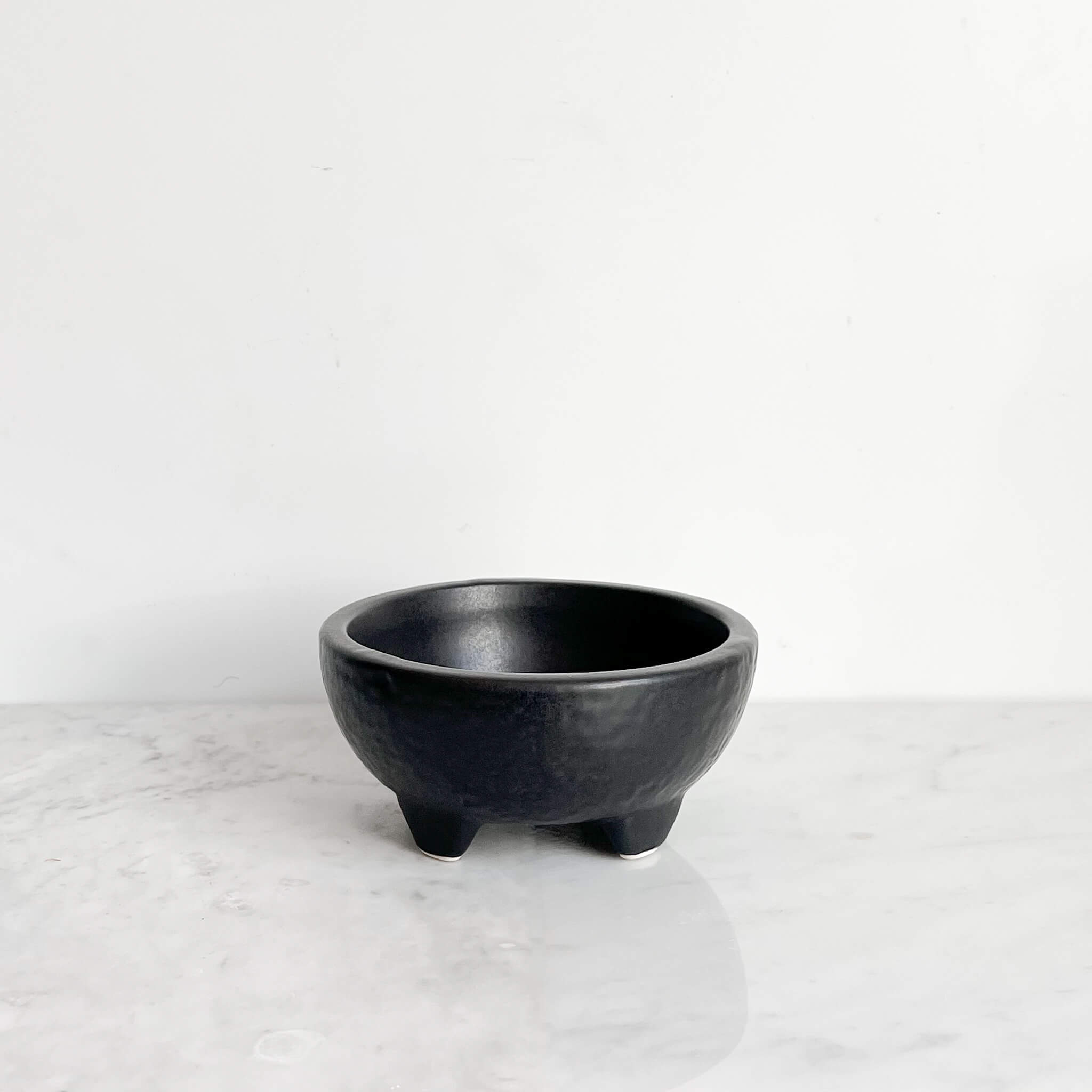 Mini ceramic molcajete bowl in black.