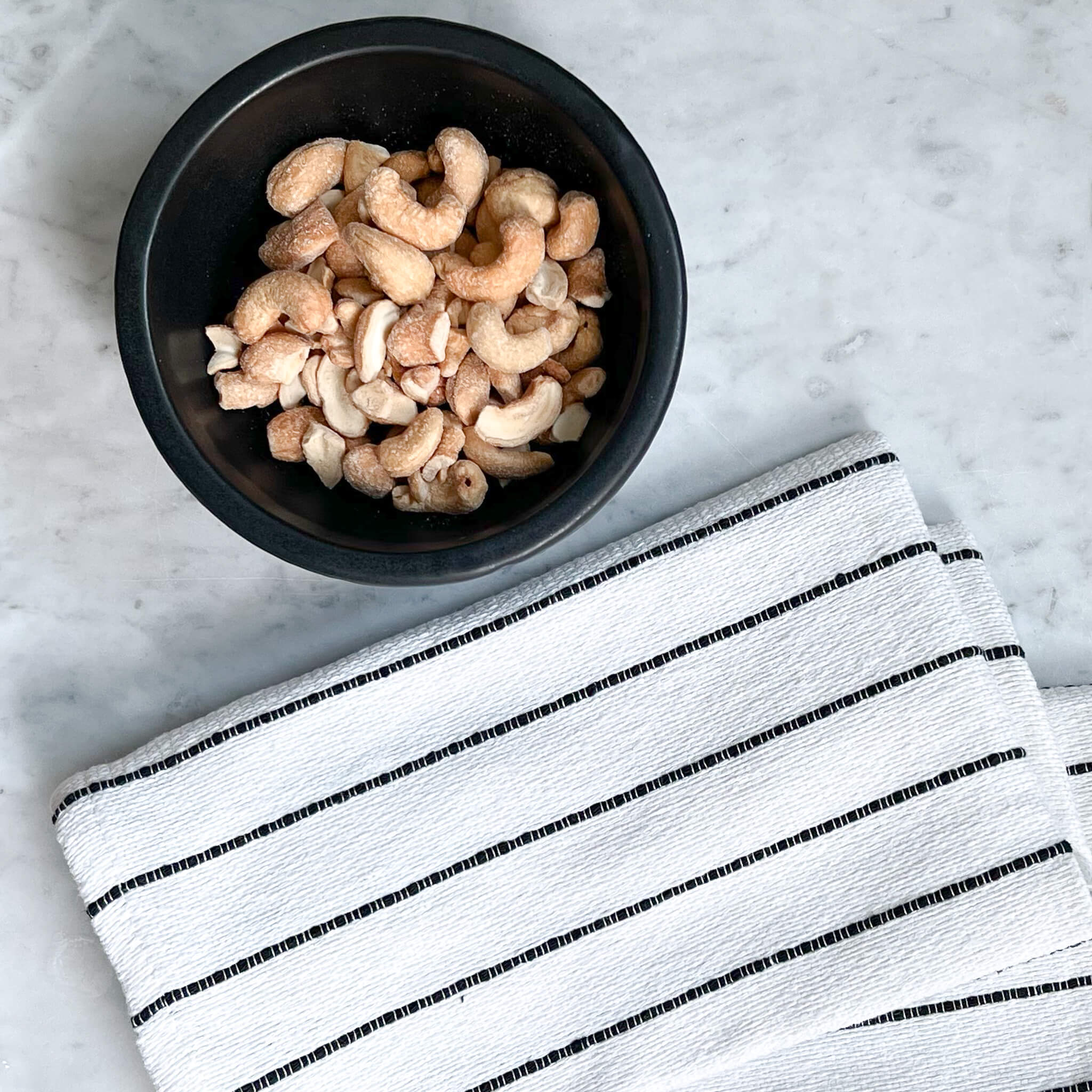 Oaxaca cotton napkins in black and white with a bowl of cashews.