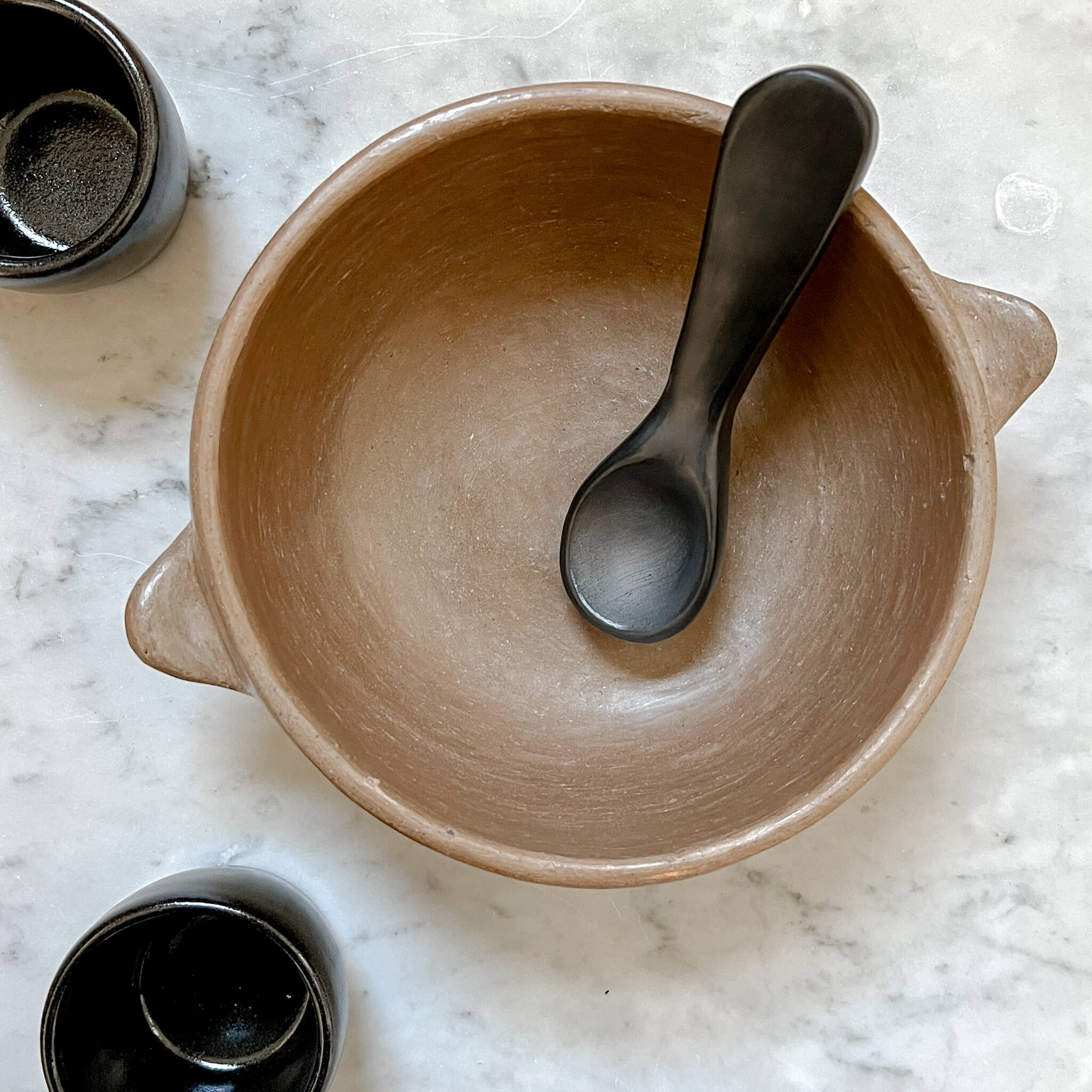 A black clay spoon made in Oaxaca, Mexico.