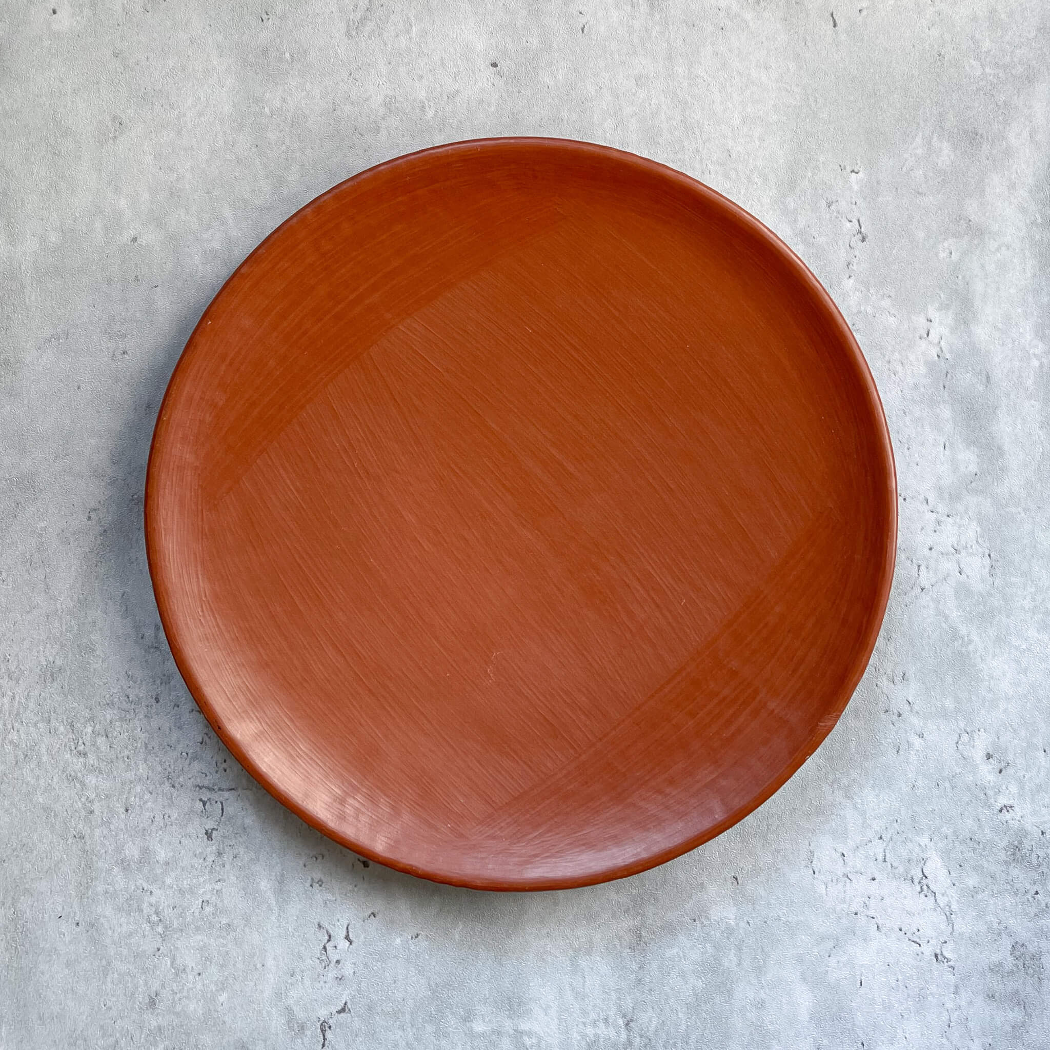 A large Oaxaca red clay dinner plate.