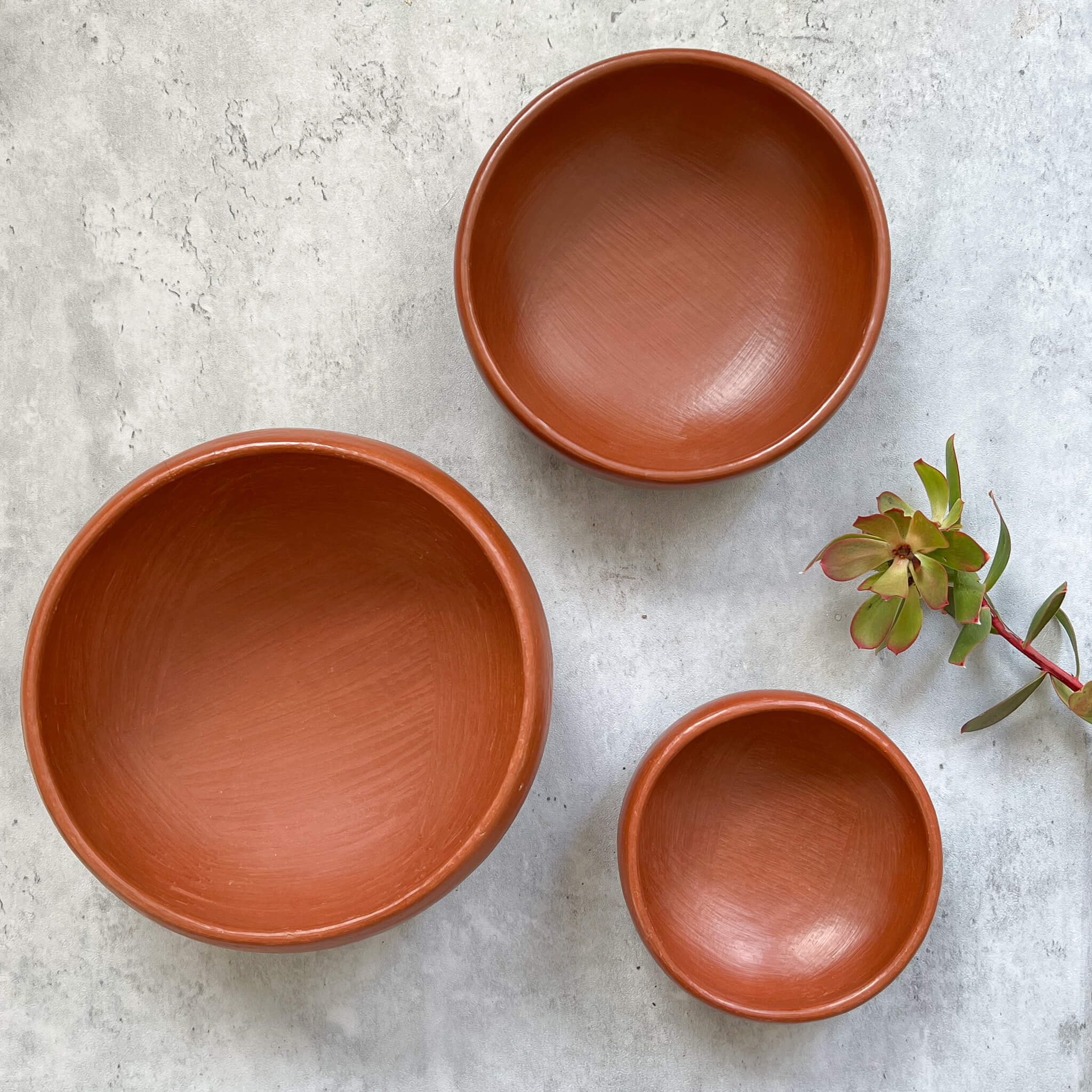 A set of 3 Oaxaca red clay round serving bowls.
