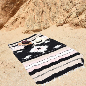 A La Rosa Mexican beach blanket on a cliff-side beach.