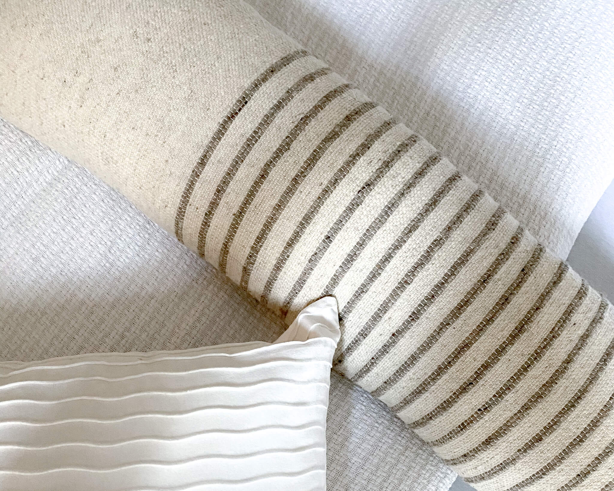 Handwoven details on a sencilla wool lumbar pillow.