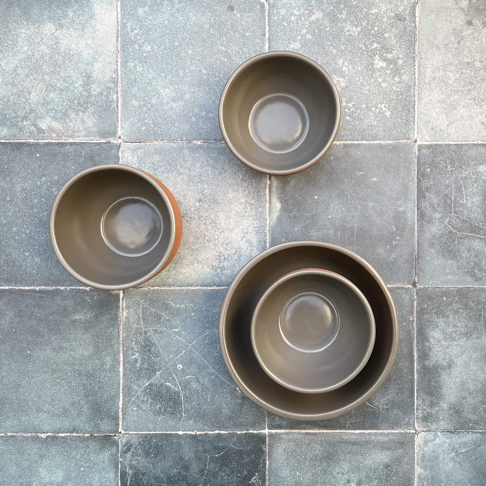 Terracotta bowls with a gray glazed interior.