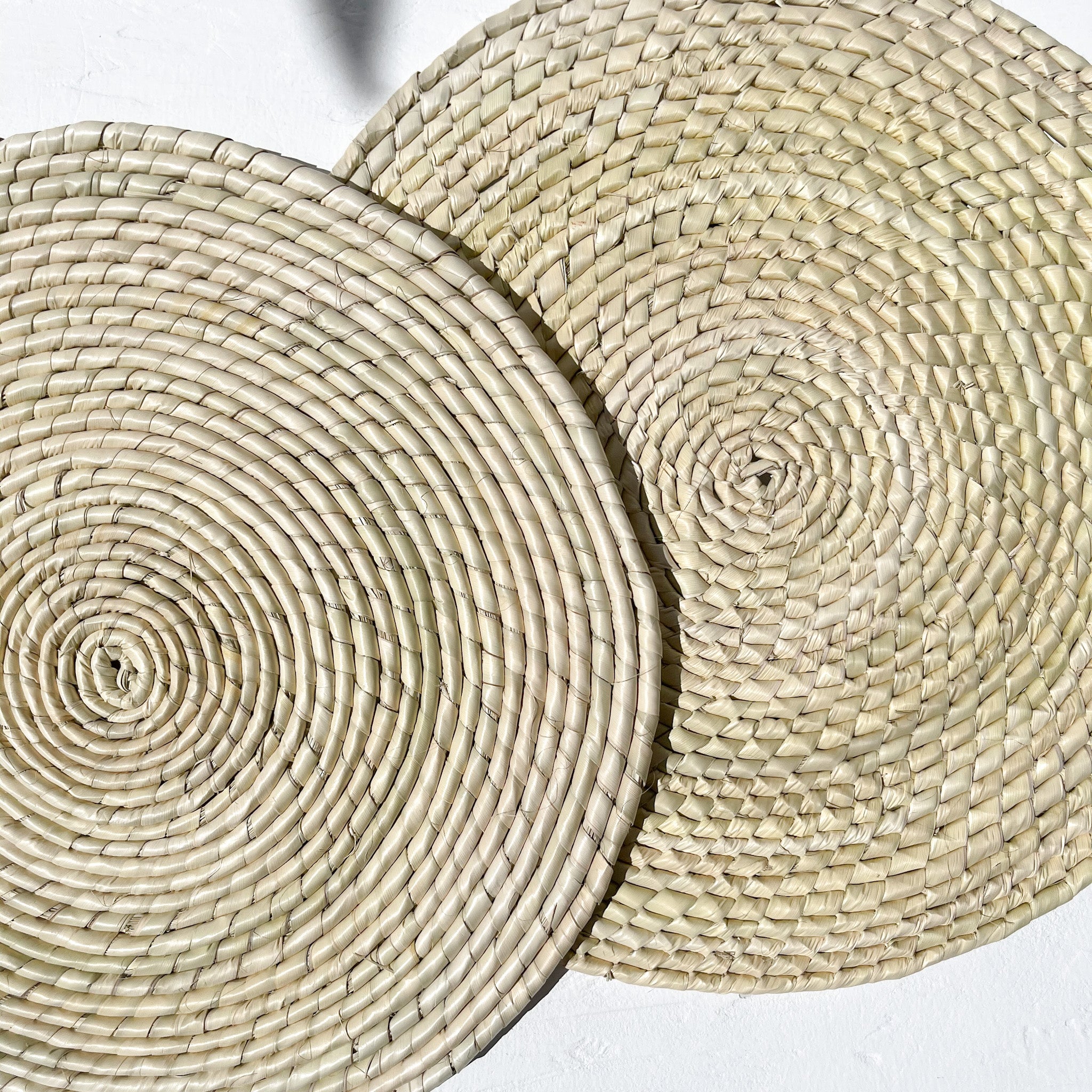 A set of handwoven palm placemats.