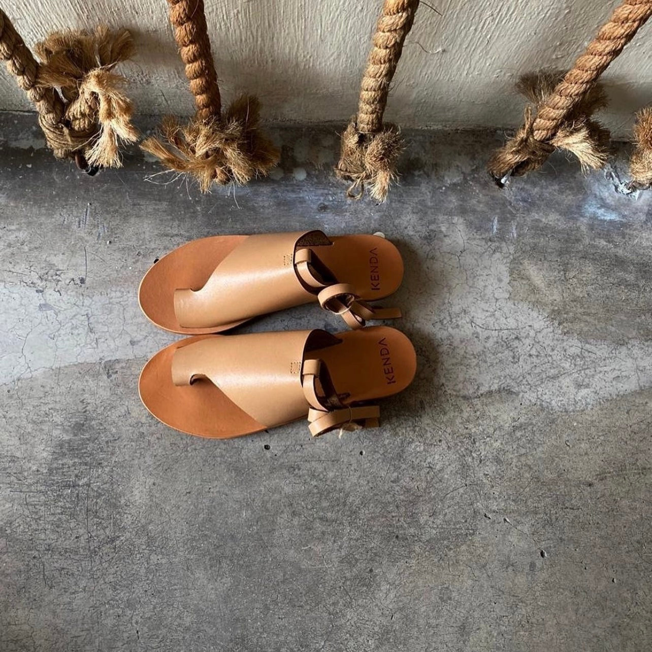 Leather suede sandals in nude with an ankle tie.