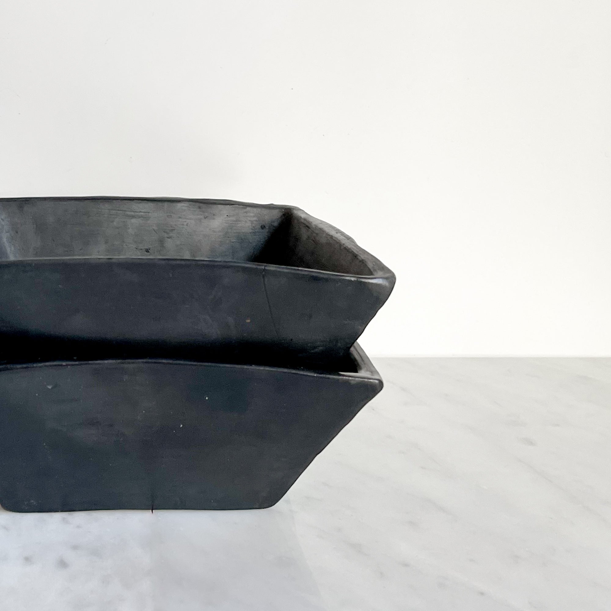 A set of two stacked Oaxaca black clay square bowls.