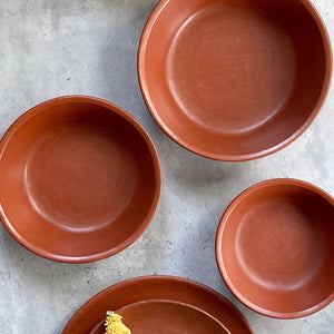 A set of red clay serving bowls made in Oaxaca.