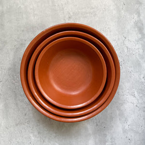 A set of Oaxacan red clay nested serving bowls.