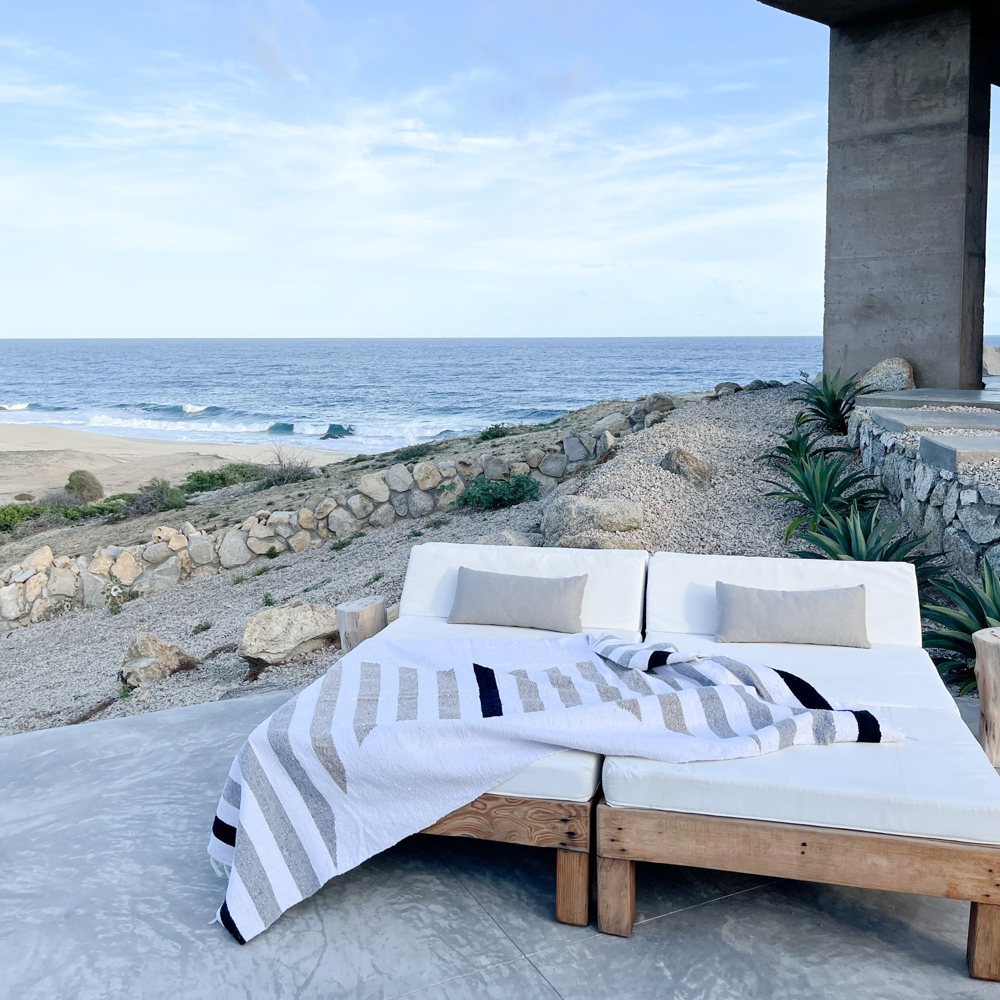 A San Borja Mexican blanket on lounge chairs overlooking the Pacific ocean in Baja, Mexico.