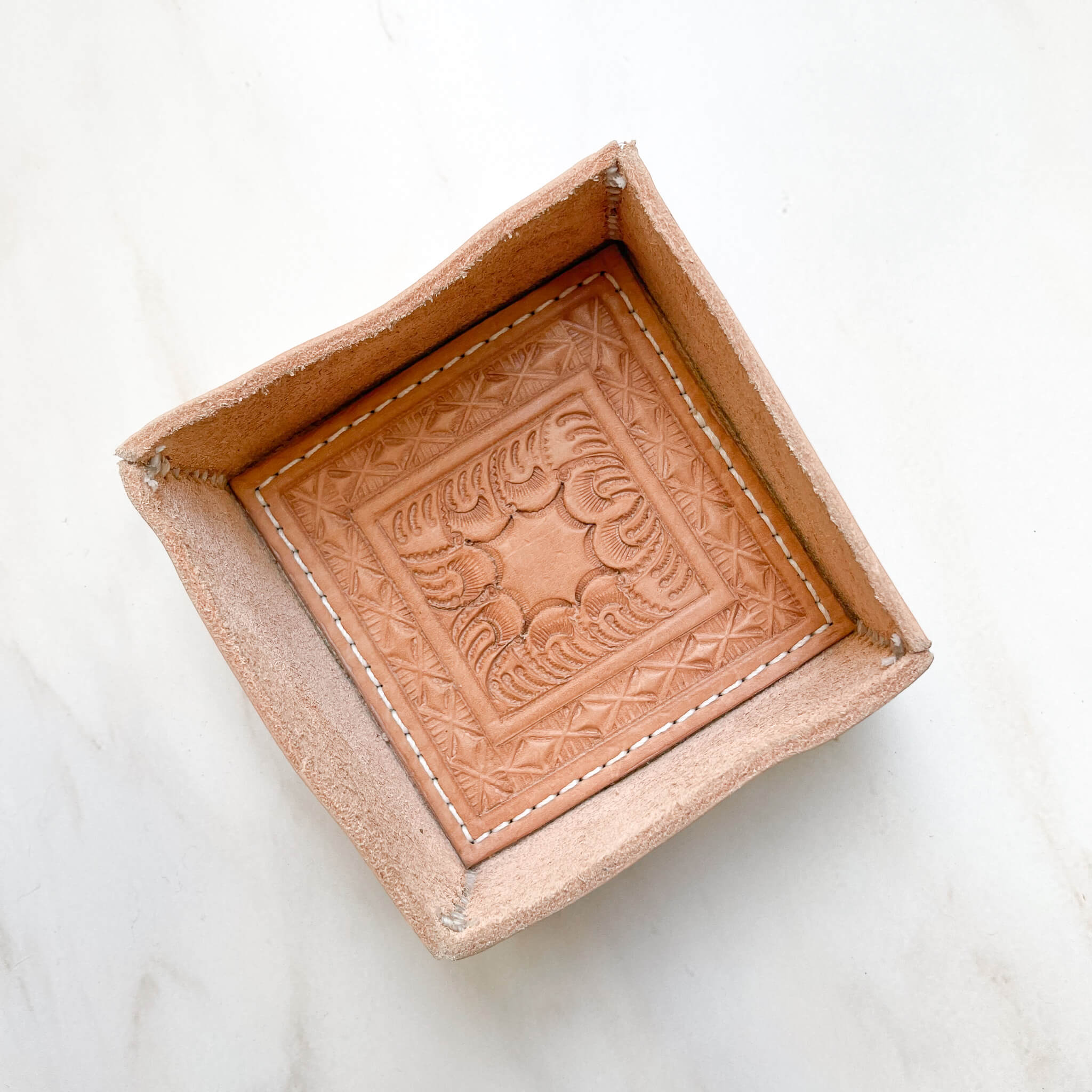 A small hand-tooled Vaquero leather tray.