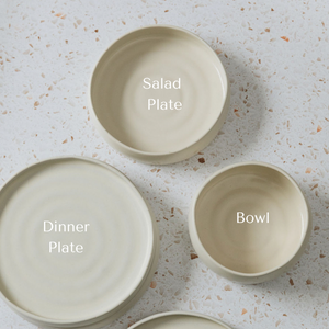 White ceramic dishes including a bowl, salad plate and dinner plate.