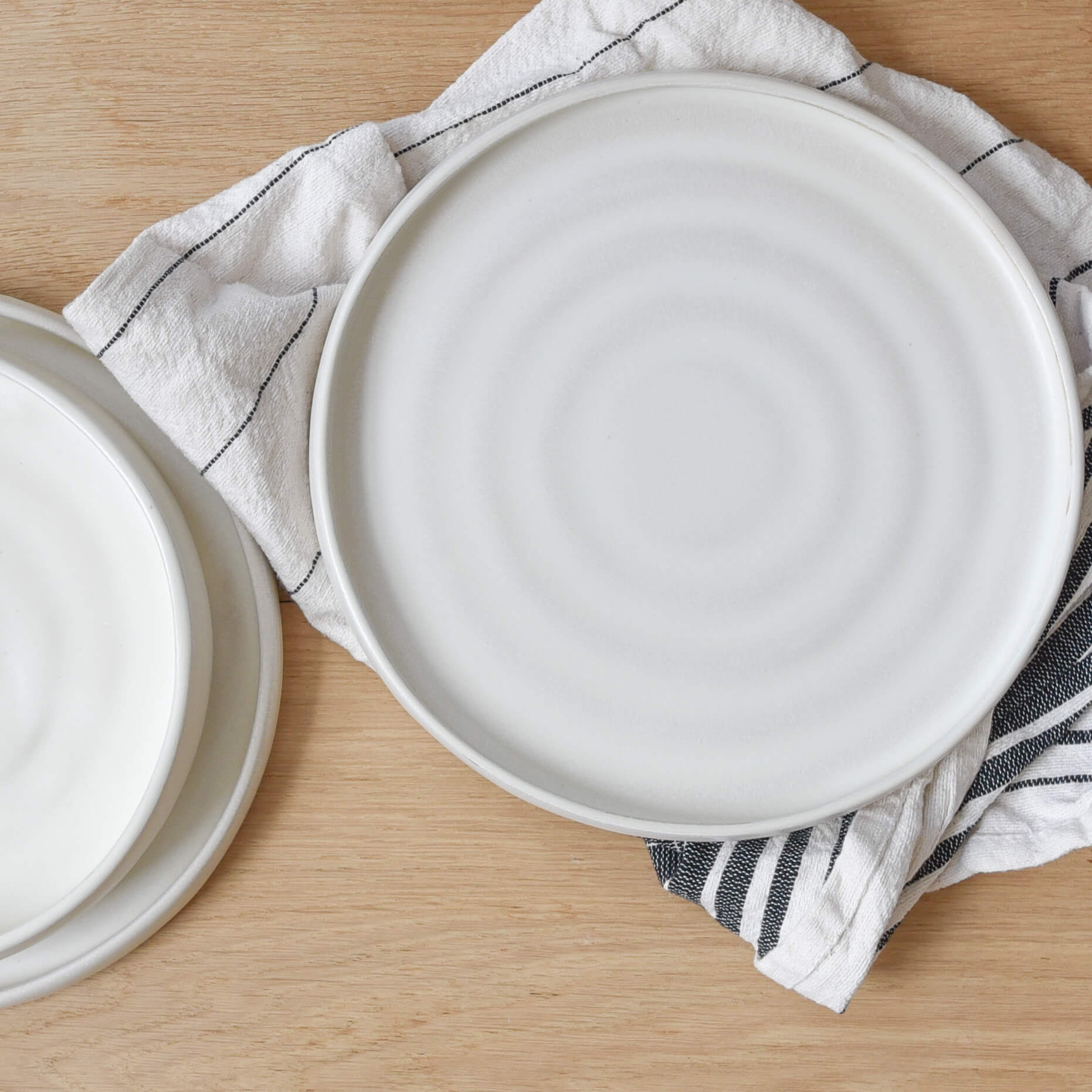 White stoneware ceramic dinner plates.